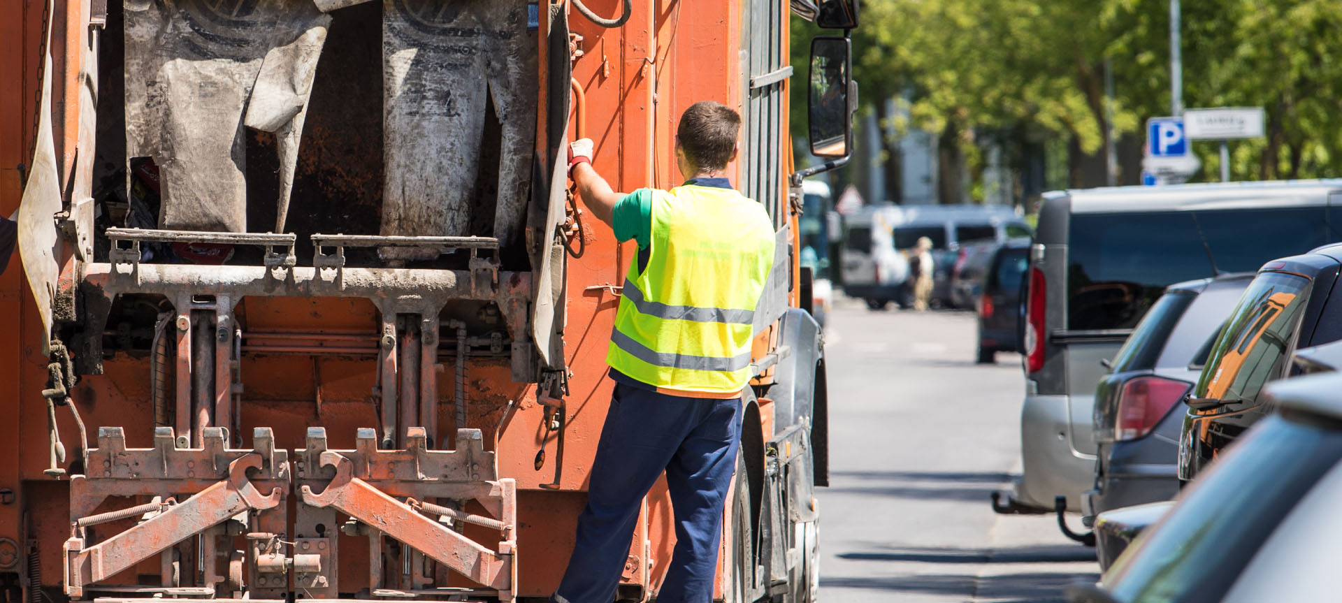 Image showing a binman hanging on the back of a bin lorry