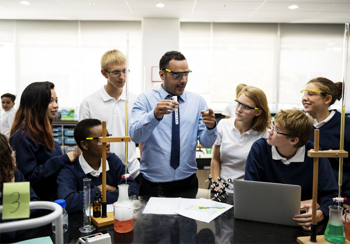 Image showing a teacher demonstrating an experiment to his high school students in science class