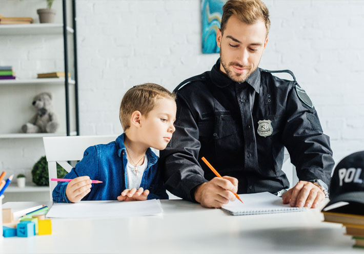 Image showing a police officer drawing with his son at home