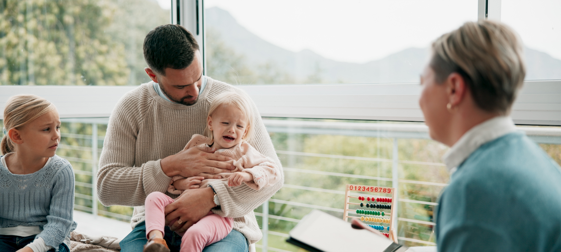 child crying in dad arms