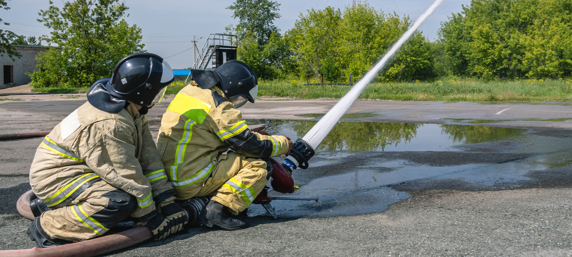 Firefighters in protective clothing extinguish the fire