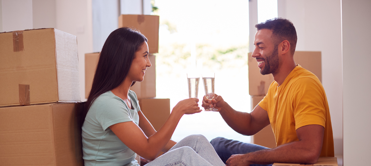 one couple is cheering near boxes