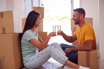 one couple is cheering near boxes