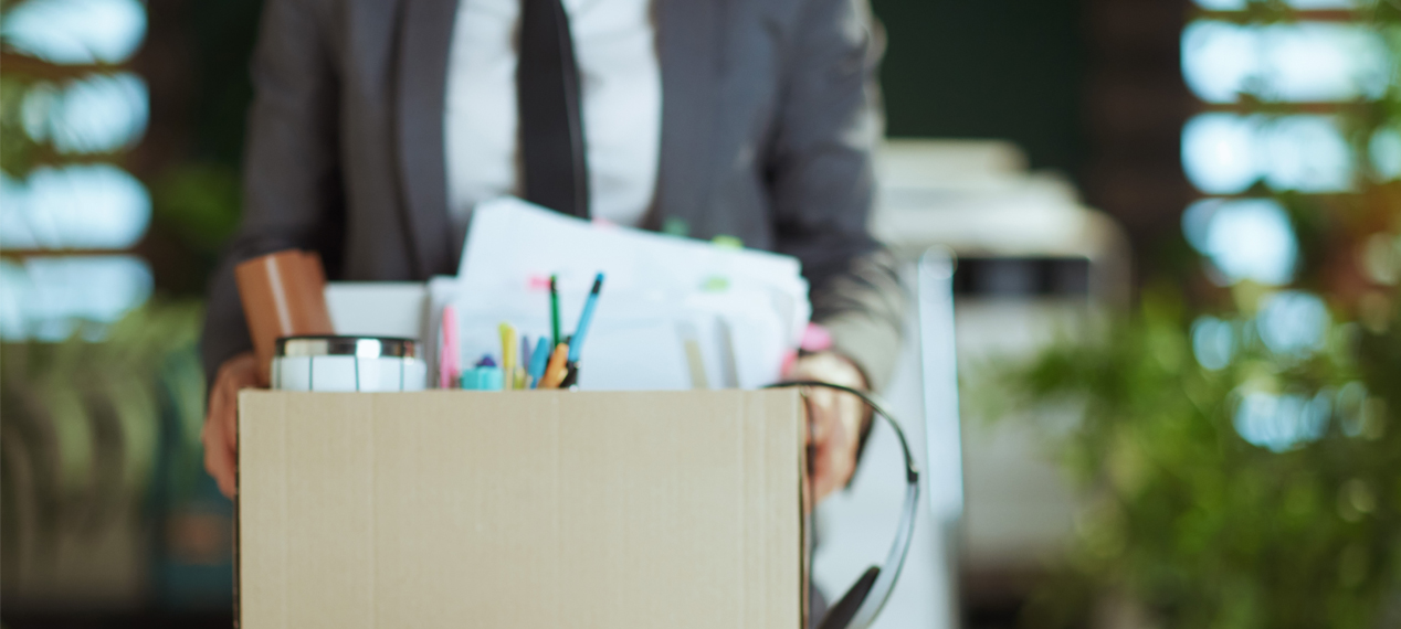 man holding a box with office supplies