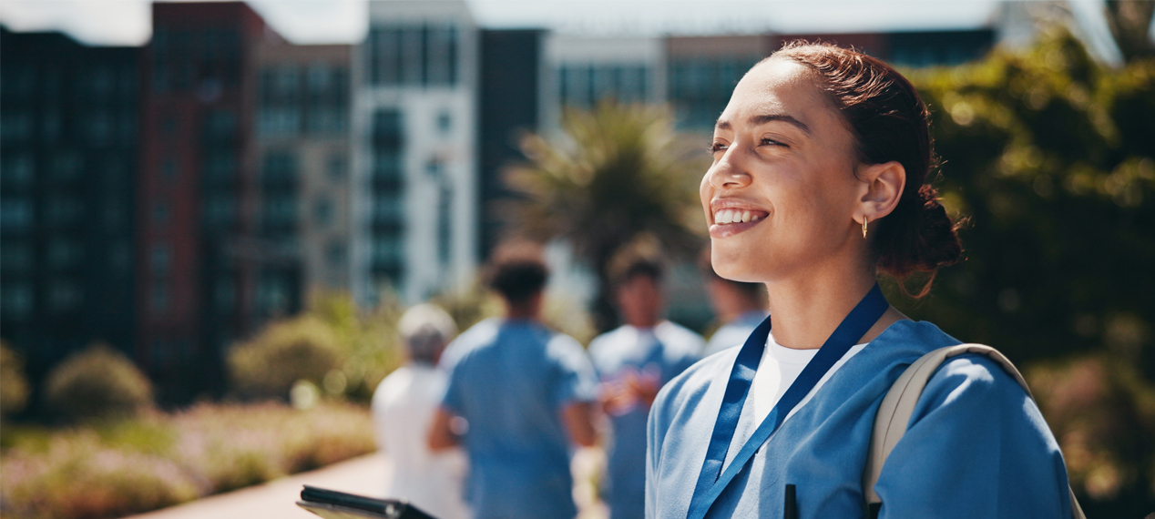 Happy doctor outside hospital