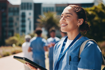 Happy doctor outside hospital