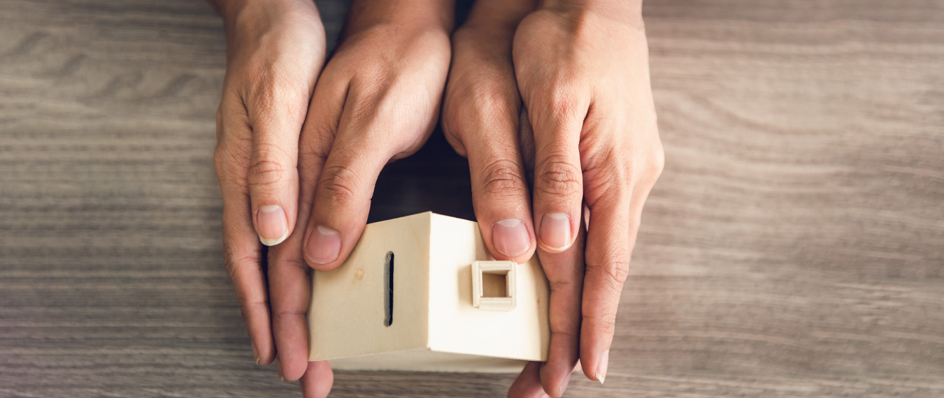 Image showing hands that hold a wooden house