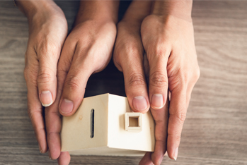 Image showing hands that hold a wooden house