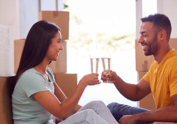 one couple is cheering near boxes