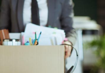 man holding a box with office supplies