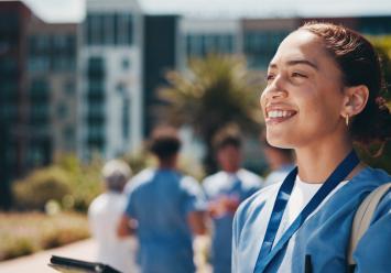 Happy doctor outside hospital