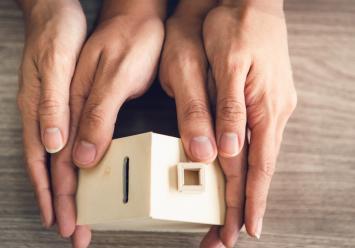 Image showing hands that hold a wooden house
