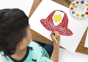 Image showing a boy painting a fireman's helmet