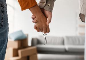 image showing a  couple holding hands and keys of a home