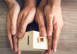 Image showing hands that hold a wooden house